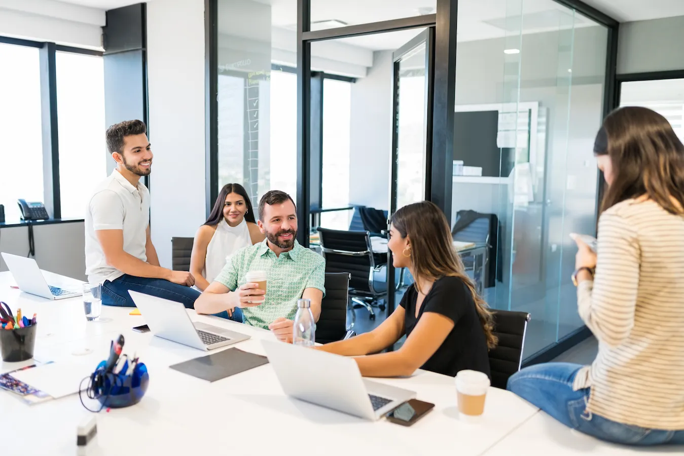 Team around a laptop, bright modern office